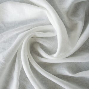 Close-up view of thick, natural Texas linen fabric showcasing its textured weave and crisp white color.