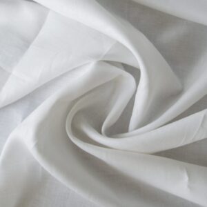 Close-up view of soft, medium-weight Toronto linen fabric showcasing its natural texture and crisp white color.