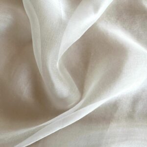 Close-up view of delicate and airy 100% mulberry silk chiffon fabric with a light weight and sheer drape in a white color.