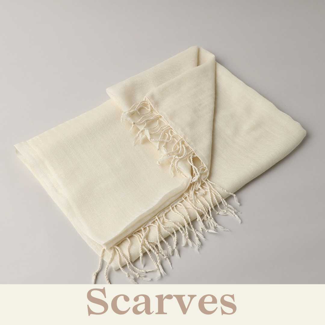 Soft, flowing scarf in half whilte with a detail.