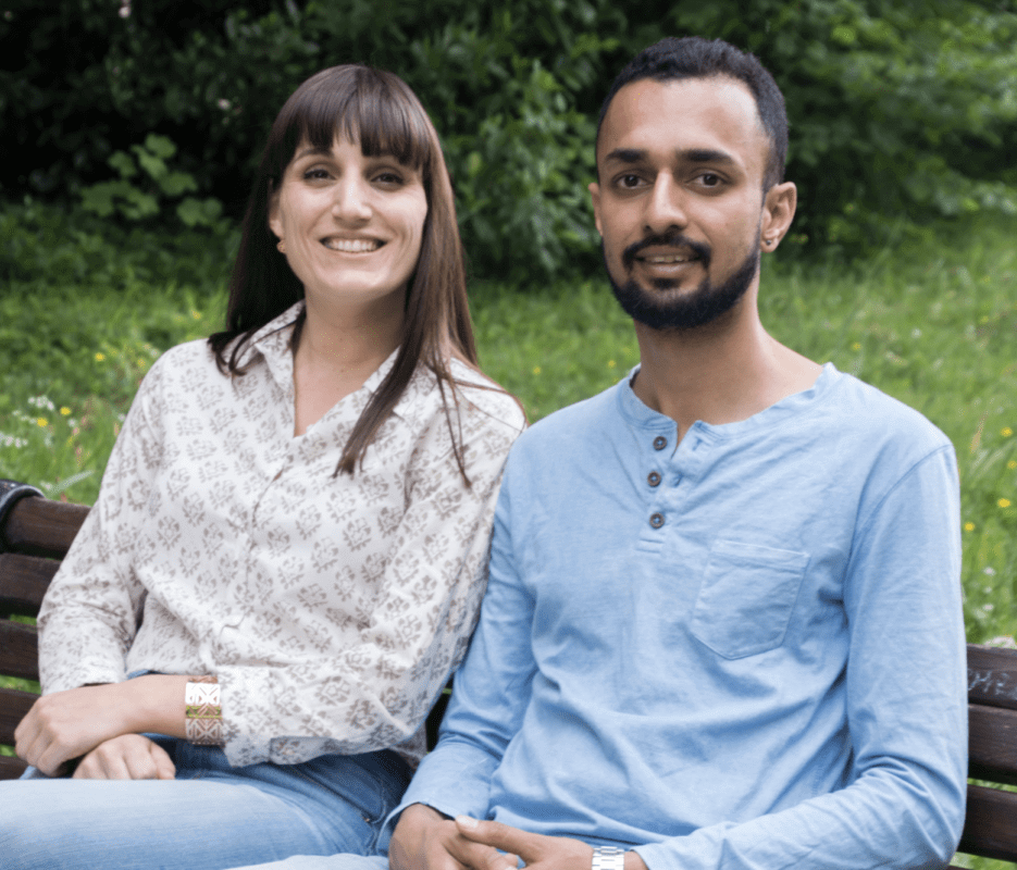 Mayank and Loha, the founders of Green Tailor, sitting together smiling.